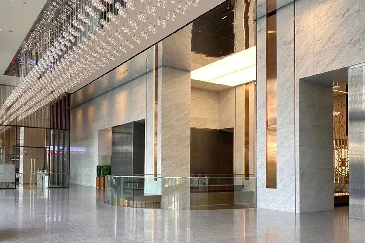 Polished marble and glass of the Emporium Tower arrival lobby